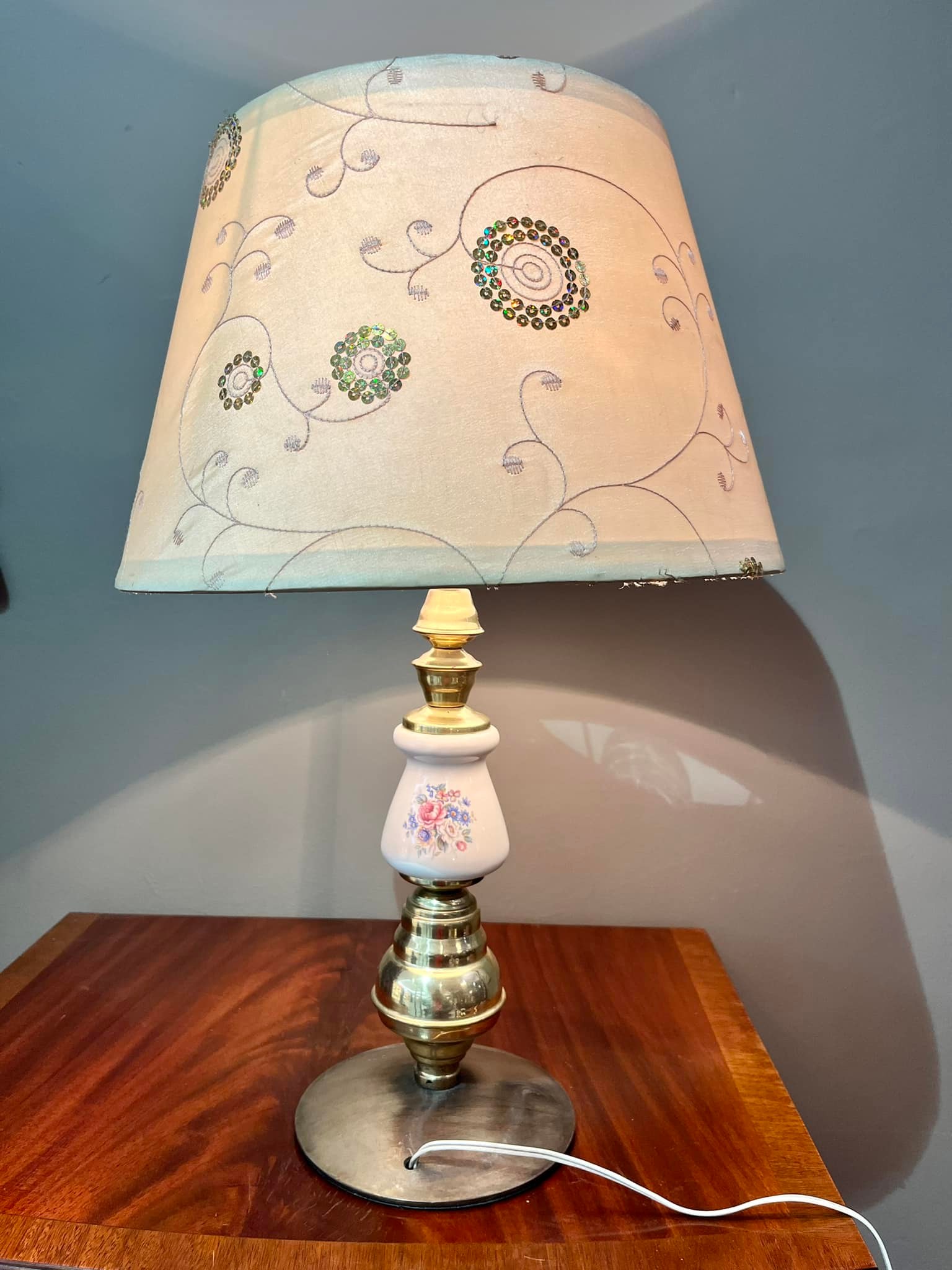 Lamp with brass and hand painted porcelain base and decorated cream shade: R800