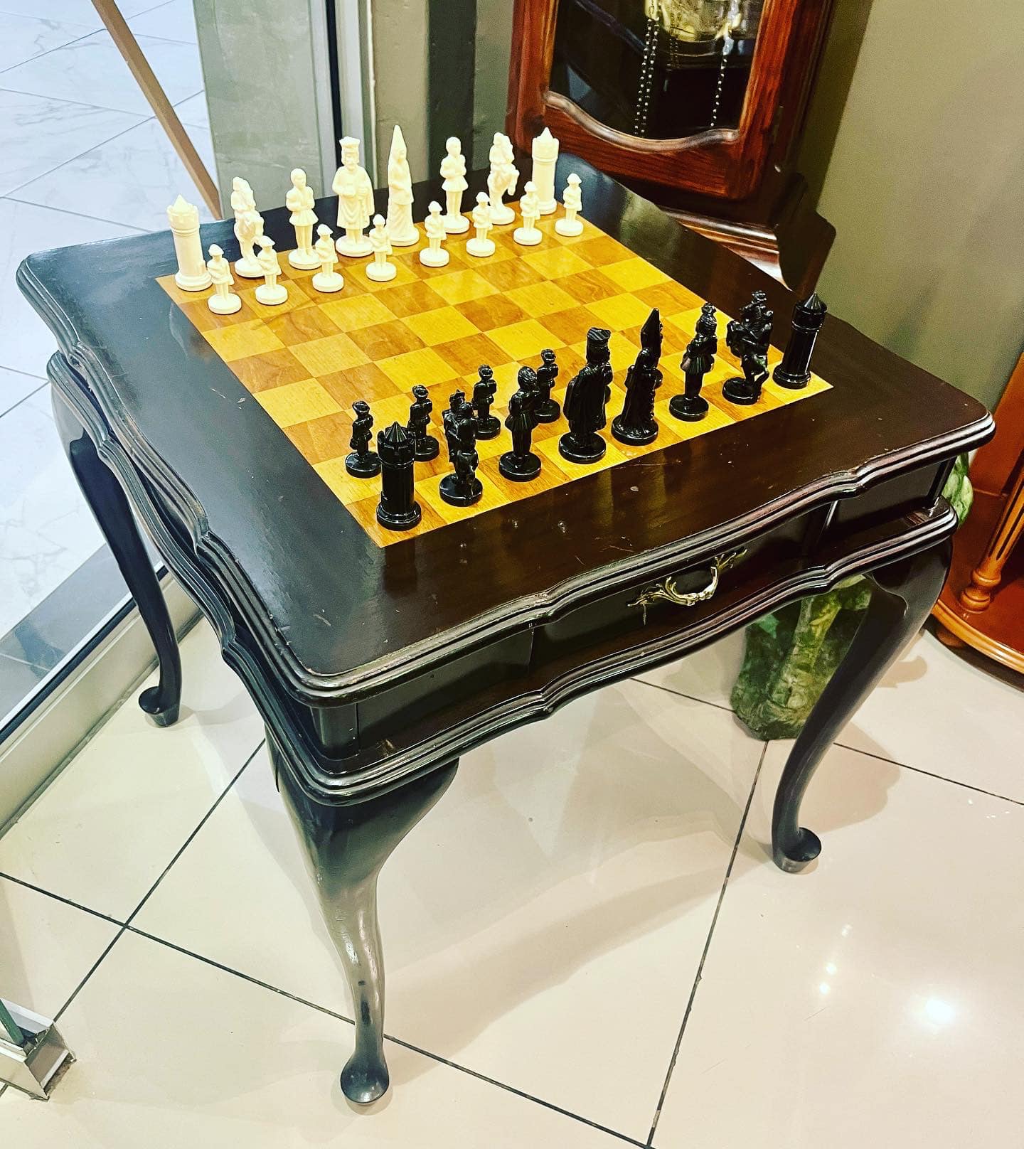 Vintage ebonised chess table with chess pieces: R8,000