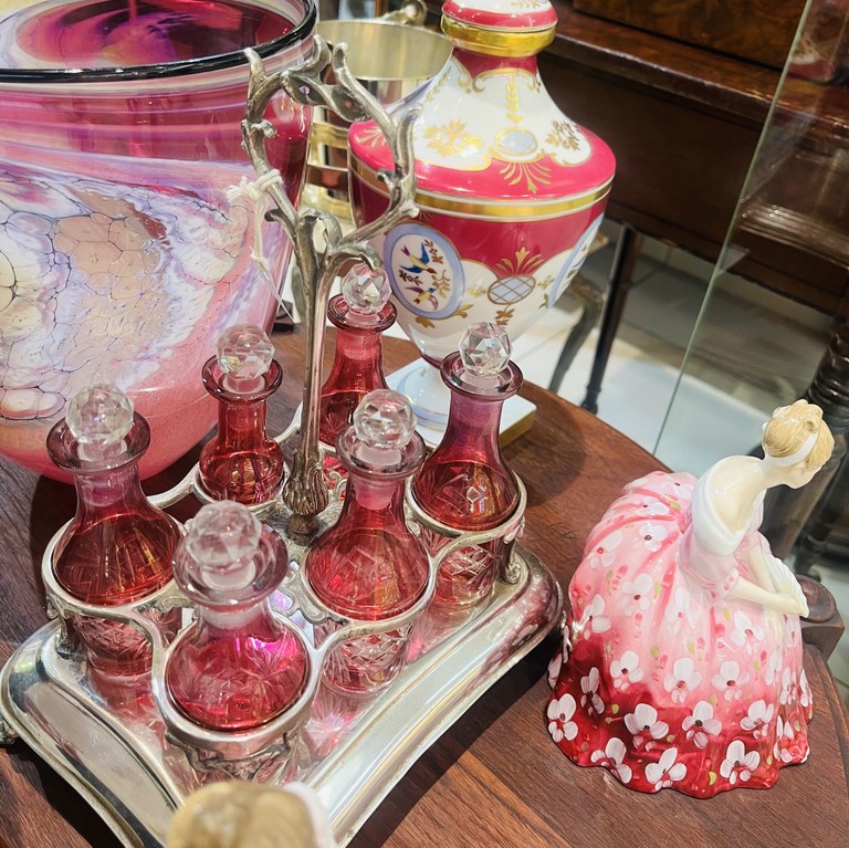 Early 1900s silver plate cruet stand with six cranberry crystal decanters