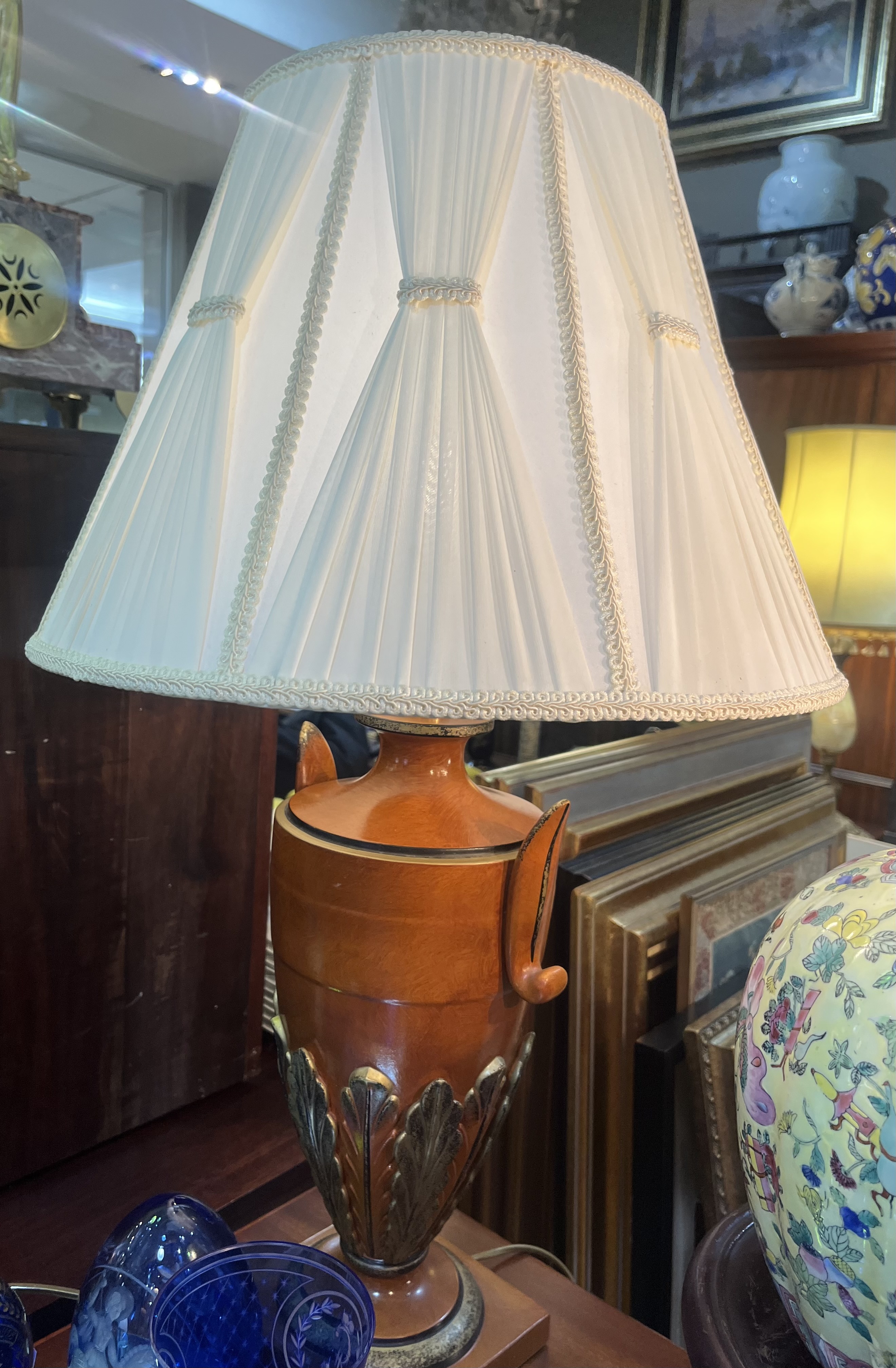 Pair of ceramic cold painted urn shaped table lamps with pleated cream shades