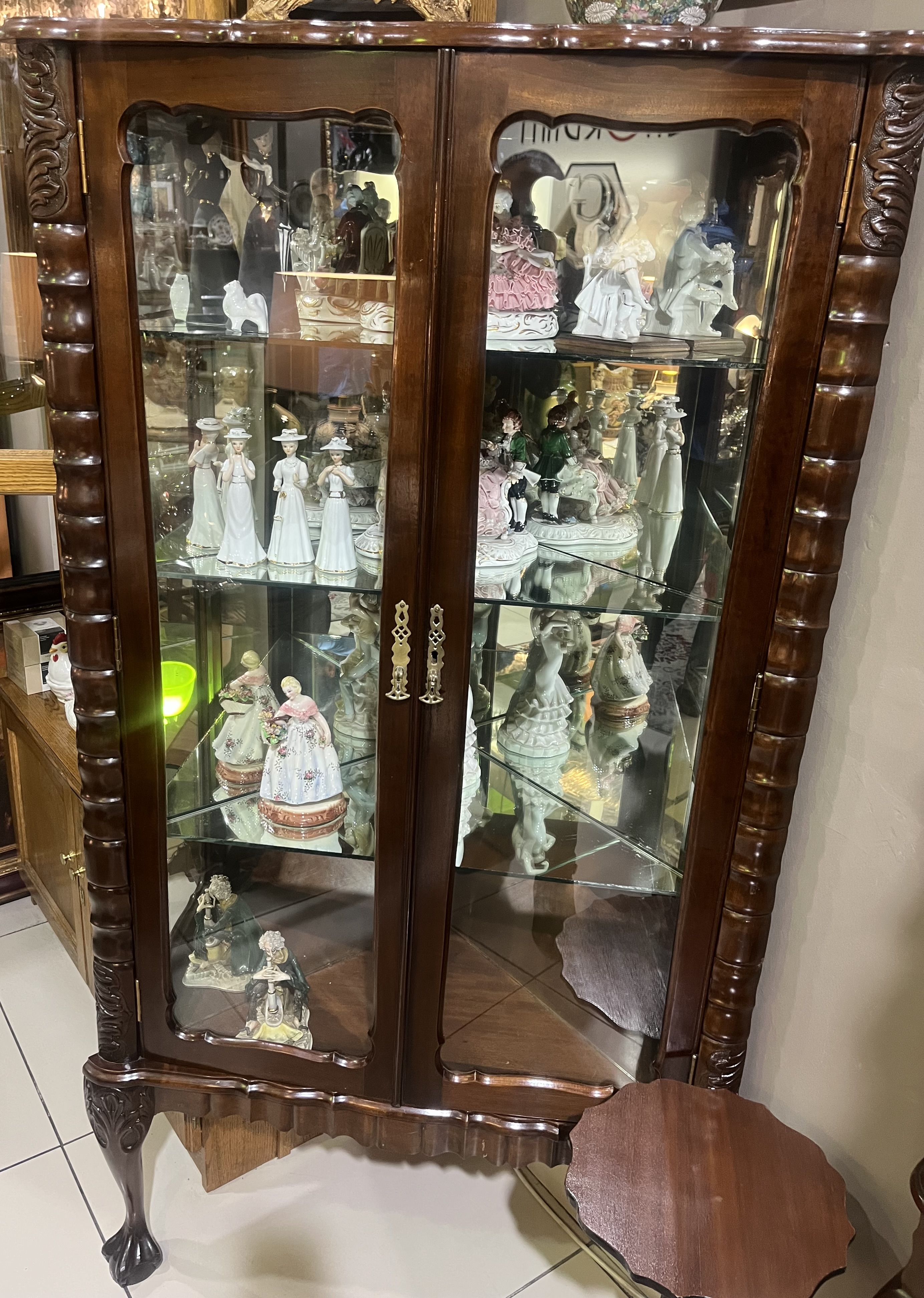 Stinkwood corner ball & claw display cabinet: R25,000